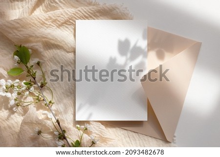 White card mockup with envelope and flowers  Royalty-Free Stock Photo #2093482678