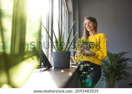 Active woman enjoying planting. Woman planting flowers. Woman plant care at home. Portrait Of Happy Arranging Potted Plants. Woman With Green Plants and Flowers at home Royalty-Free Stock Photo #2093483929