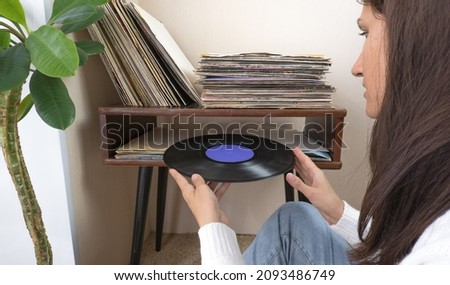 Playing vinyl records. Listening music, leisure time, staying home.