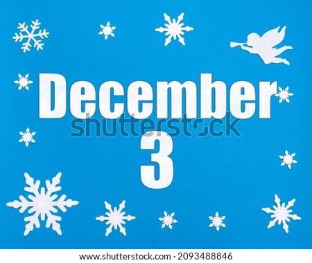 December 3rd. Winter blue background with snowflakes, angel and a calendar date. Day 3 of month. Winter month, day of the year concept.