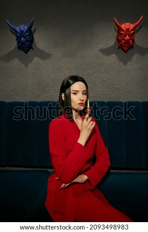 Anime woman in a red suit with short hair cut, black hair. A killer girl in a red jacket with a dagger in her hand. Beauty portrait
