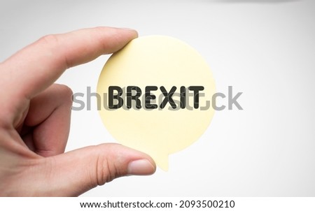 Human hands holding a bubble speech of words brexit in all blue backgroundd