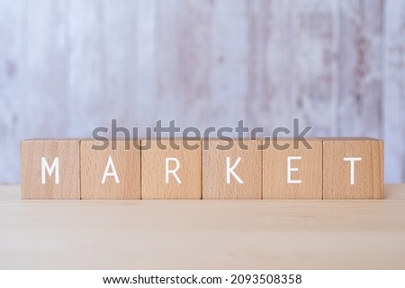Wooden blocks with "MARKET" text of concept.