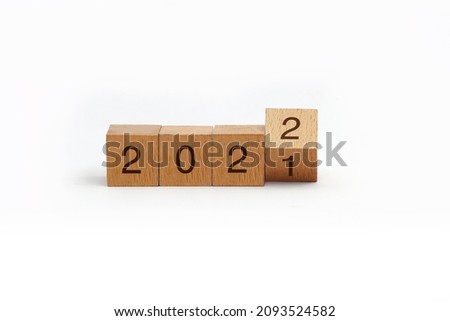 flipping cubes with year 2021 to 2022. new year concept. copy space. 3D wooden cube flip over wooden block isolated in white background Royalty-Free Stock Photo #2093524582