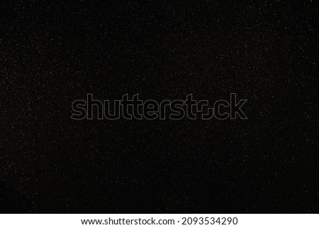 Chaotic bright lights on a black background imitating stars in open space
