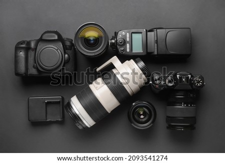 Modern photographer's equipment on dark background