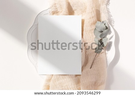 White card mockup with eucalyptus 
