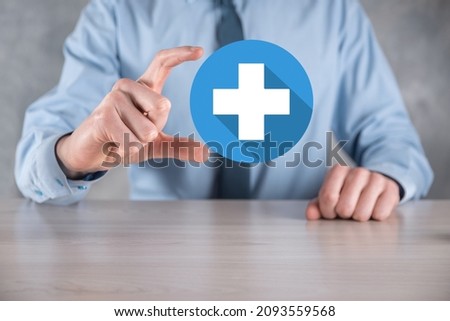 Businessman hold plus icon, man hold in hand offer positive thing such as profit, benefits, development, CSR represented by plus sign.The hand shows the plus sign.flat icons with long shadows.