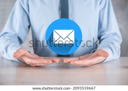 Businessman hand holding letter icon,email icons.Contact us by newsletter email and protect your personal information from spam mail.Customer service call center contact us.Email marketing newsletter