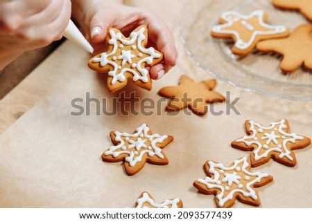 Christmas ginger cookies in the hands decorated with icing