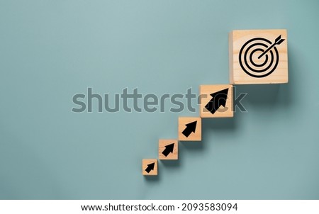 Virtual target board and arrow which print screen on wooden cube. Business achievement goal and objective target concept.
