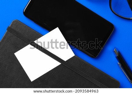 White businesscard with copy space on black notepad Royalty-Free Stock Photo #2093584963