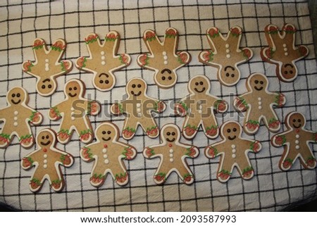 Christmas gingerbread men in the form of cookies. Home cooking. Homemade cookies are spread out on the table. Christmas cookies. Cookies with a gingerbread man on the table, prepared at home.