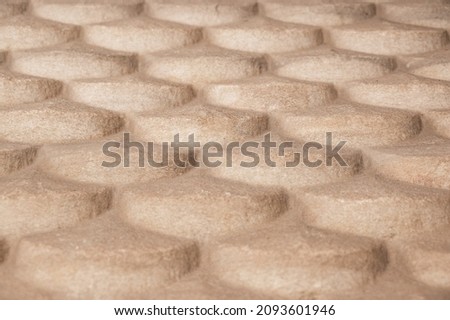 Nice background of beige stone tiles with rounded edges from a single piece of stone
