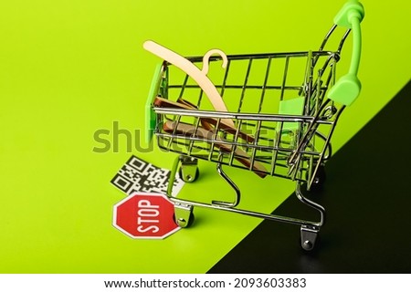 supermarket trolley with clothes hangers moves stop sign. life without covid.