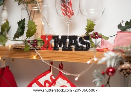 the inscription "christmas" on the shelf against the background of kitchen utensils. christmas concept.
