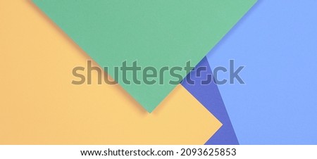 Creative abstract light blue, pastel green, purple and yellow color geometric paper compositon background, top view