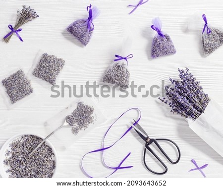 Lavender sachets home and wardrobe fragrance freshener, natural anti-repellent, transparent bags from organza with scented dried flowers, on white wooden table. Aromatherapy and herbal medicine. Royalty-Free Stock Photo #2093643652