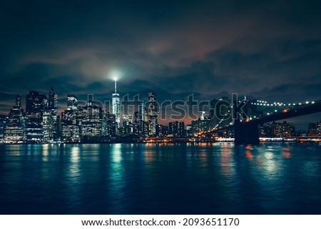 View of New York with Brooklyn bridge by night, USA.
