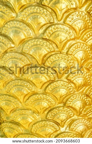 Golden yellow serpent scale statue texture with seamless patterns for background