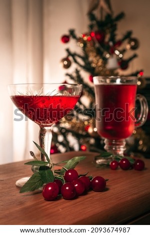 Flavored red fruit cider accompanied by cherries, background Christmas themes