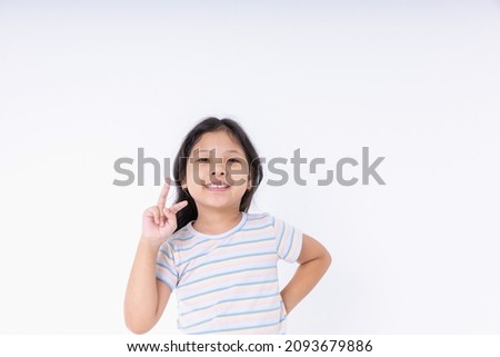 Asian kid girls are very cute smiles very happy, cheerful, bright, positive attitude, Photography standing in a studio with white background and copy space.