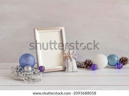 Christmas decoration, frame mockup, blue garland on a white table, copy space