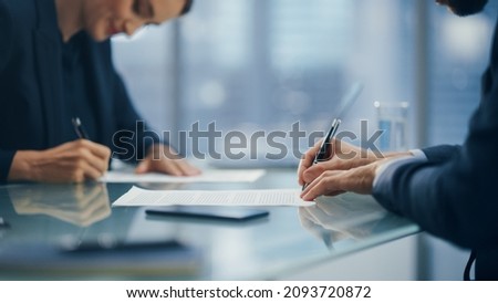 Close Up on Hands of Business Partners Sign Successful Deal Documents in Meeting Room Office. Corporate CEO and Investment Manager Working Next to Window with Big City with Skyscrapers View.