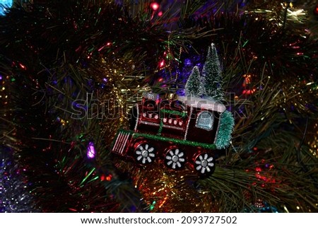Christmas train ornament hanging from a Christmas tree 