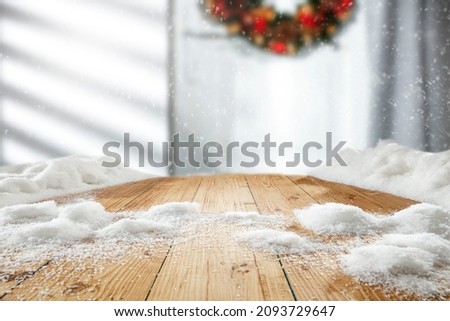 Wooden table with snow, free space, winter background