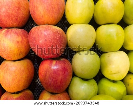 red and green apples on supermarket display make pattern