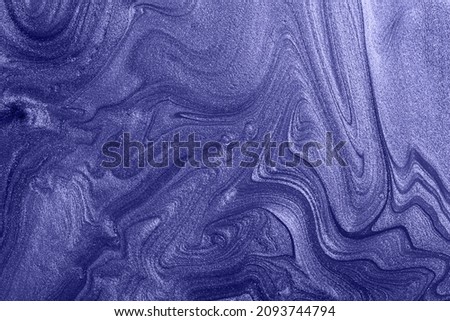 Beautiful shimmer stains of liquid nail polish,colored in trendy violet color of 2022. Royalty-Free Stock Photo #2093744794