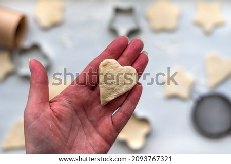 Female hand holds gingerbread cookie in the form of heart. St. Valentine's day, Christmas, New Year concept, festive preparations for winter hilodays. 14 february
