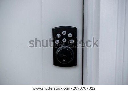 Front angle view of a front door lock, with both key and pin number secure entry options Royalty-Free Stock Photo #2093787022