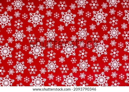 White snowflakes on a red background wrapping paper. Christmas Holiday concept.