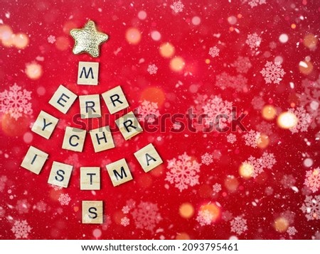 Christmas tree of letters with Christmas on a red background. Christmas holiday concept.