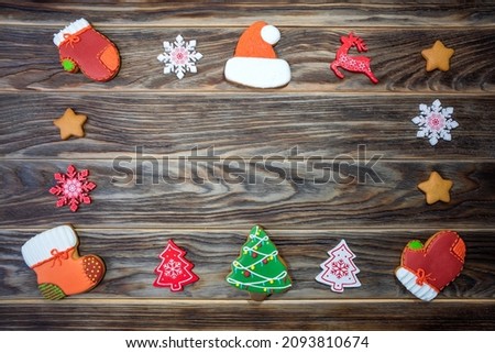 Christmas and New Year concept. Dark brown wooden background, gingerbread cookies, Christmas decorations. Place for text, selective focus. Horizontal photo. Kyiv (Kiev), Ukraine, Europe.