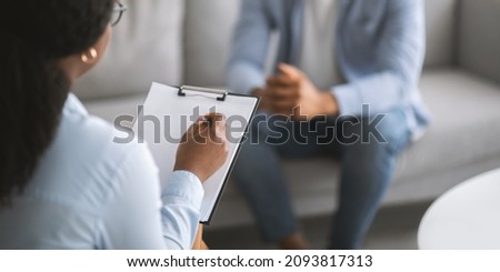 Professional psychotherapy. Female psychologist having session with young male patient at mental health clinic, selective focus. Banner design with copy space. Treatment of depression concept Royalty-Free Stock Photo #2093817313