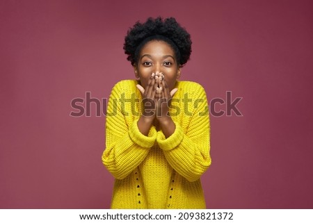 Amazed excited young african american girl surprised by good news cover mouth on pink studio background. Incredible sale