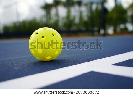 Close up of a pickleball on a pickleball court.                         Royalty-Free Stock Photo #2093838892