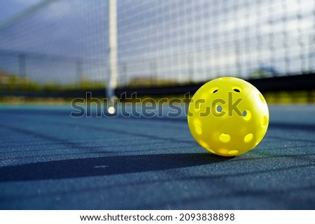 Close up of a pickleball on a pickleball court.                         Royalty-Free Stock Photo #2093838898