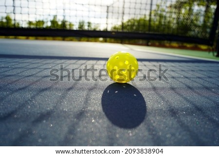 Close up of a pickleball on a pickleball court.                         Royalty-Free Stock Photo #2093838904