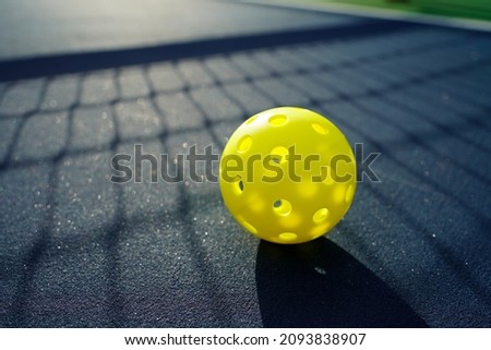 Close up of a pickleball on a pickleball court.                         Royalty-Free Stock Photo #2093838907