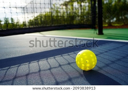 Close up of a pickleball on a pickleball court.                         Royalty-Free Stock Photo #2093838913