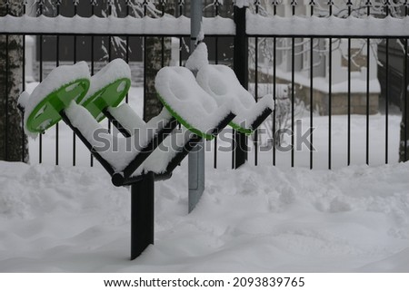 Winter cyclone. Snowfall in the city. Sports ground covered with snow. High quality photo