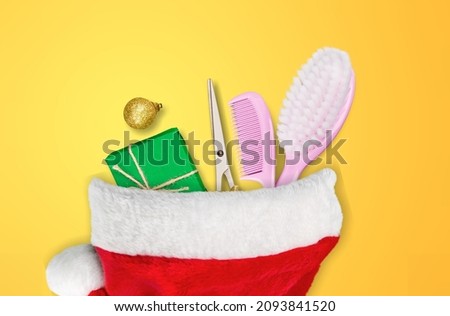 Christmas composition. Hairdressing tools in a Santa Claus hat, hair salon.