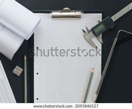 Note in workspace with tablet. POV. Copy space