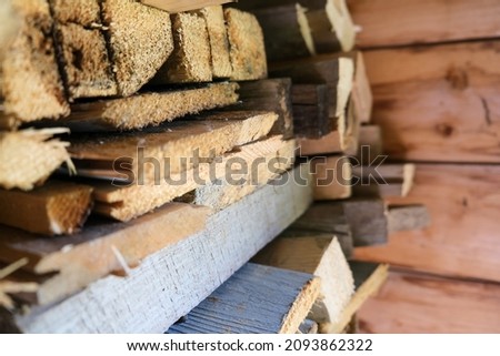 A stack of carpentery waste using as firewood, sustainable, rational and effective use of wood for heating house