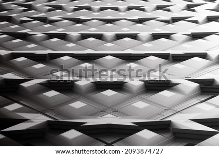 Double exposure photo of windows. Grunge low angle view. Abstract modern architecture. Concrete building exterior. Hi-tech geometric structure with regular pattern of polygonal elements.