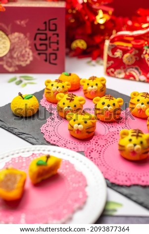 Home made pastry baked Spring Chinese New Year decorations sweet pineapple tart snack for Lunar festive Tiger 2022. Foreground blur.